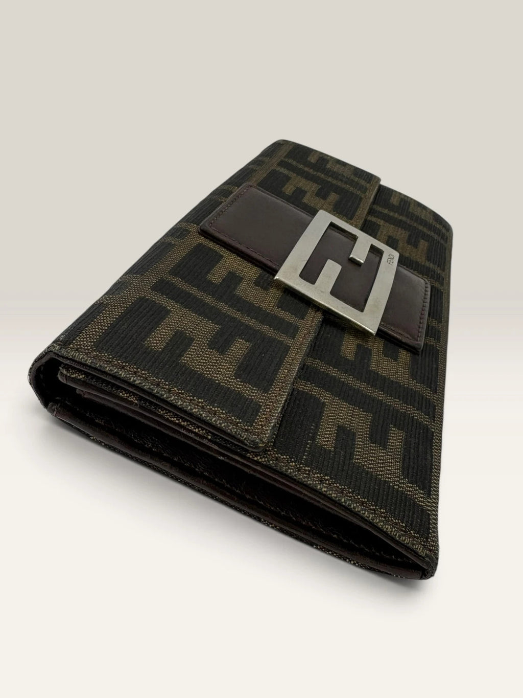 Fendi brown long wallet with Zucca FF monogram canvas and oversized logo buckle.