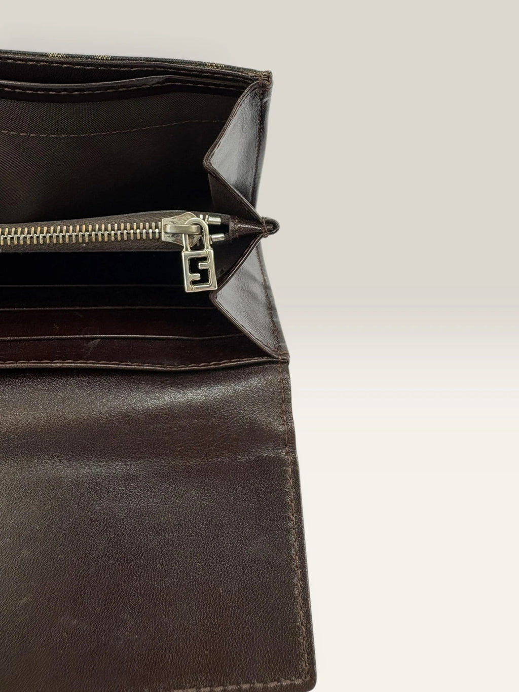Fendi brown long wallet with Zucca FF monogram canvas and oversized logo buckle.