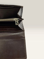 Fendi brown long wallet with Zucca FF monogram canvas and oversized logo buckle.