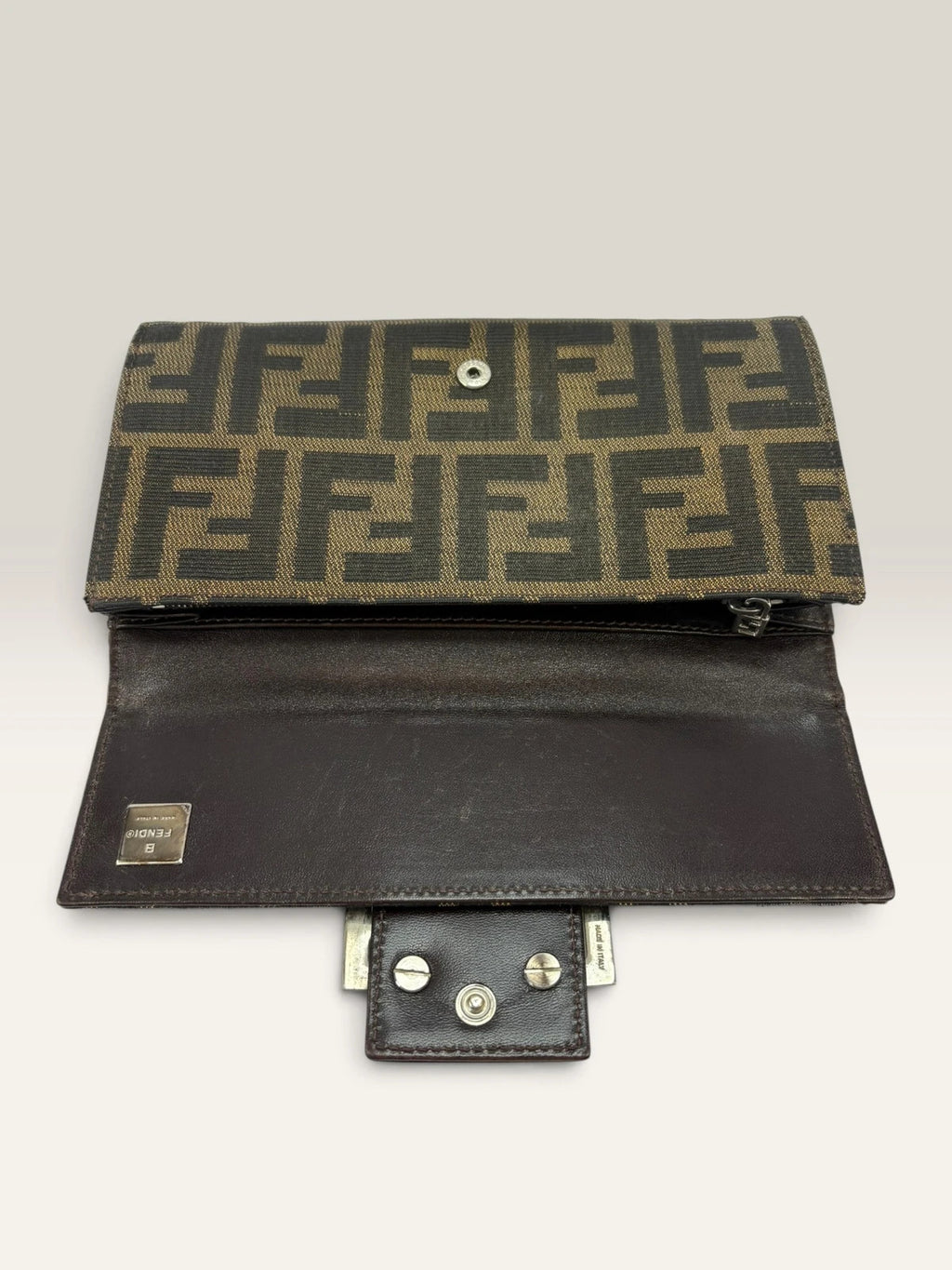 Fendi brown long wallet with Zucca FF monogram canvas and oversized logo buckle.