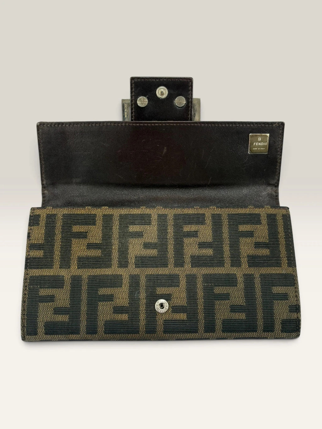 Fendi brown long wallet with Zucca FF monogram canvas and oversized logo buckle.