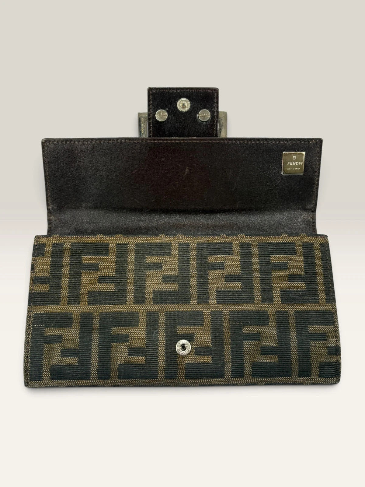 Fendi brown long wallet with Zucca FF monogram canvas and oversized logo buckle.