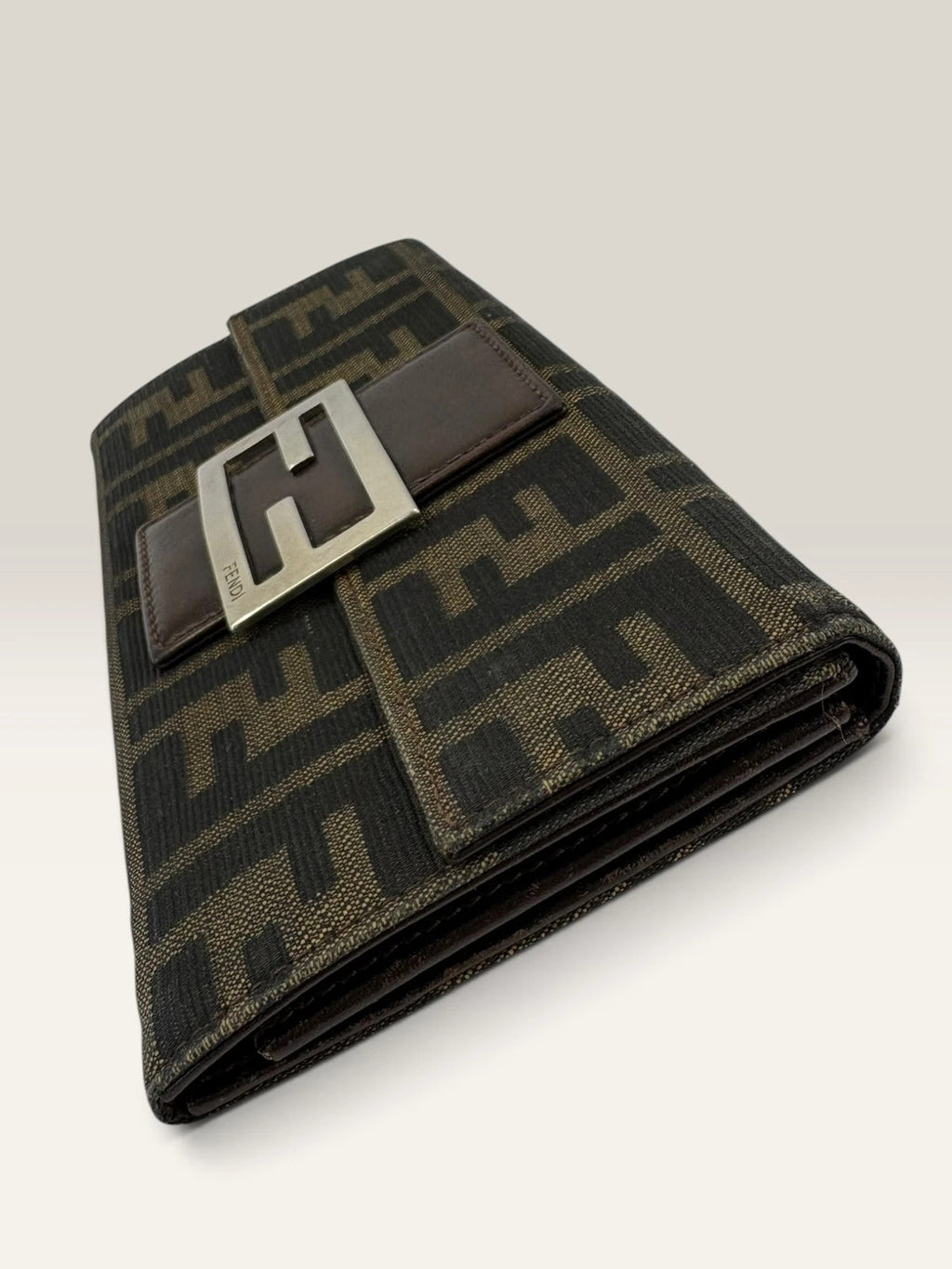 Fendi brown long wallet with Zucca FF monogram canvas and oversized logo buckle.