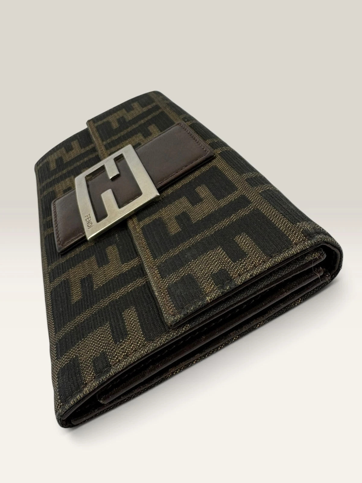 Fendi brown long wallet with Zucca FF monogram canvas and oversized logo buckle.