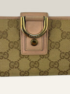 Gucci beige pink long wallet GG canvas with gold-tone Horsebit clasp and leather trim.