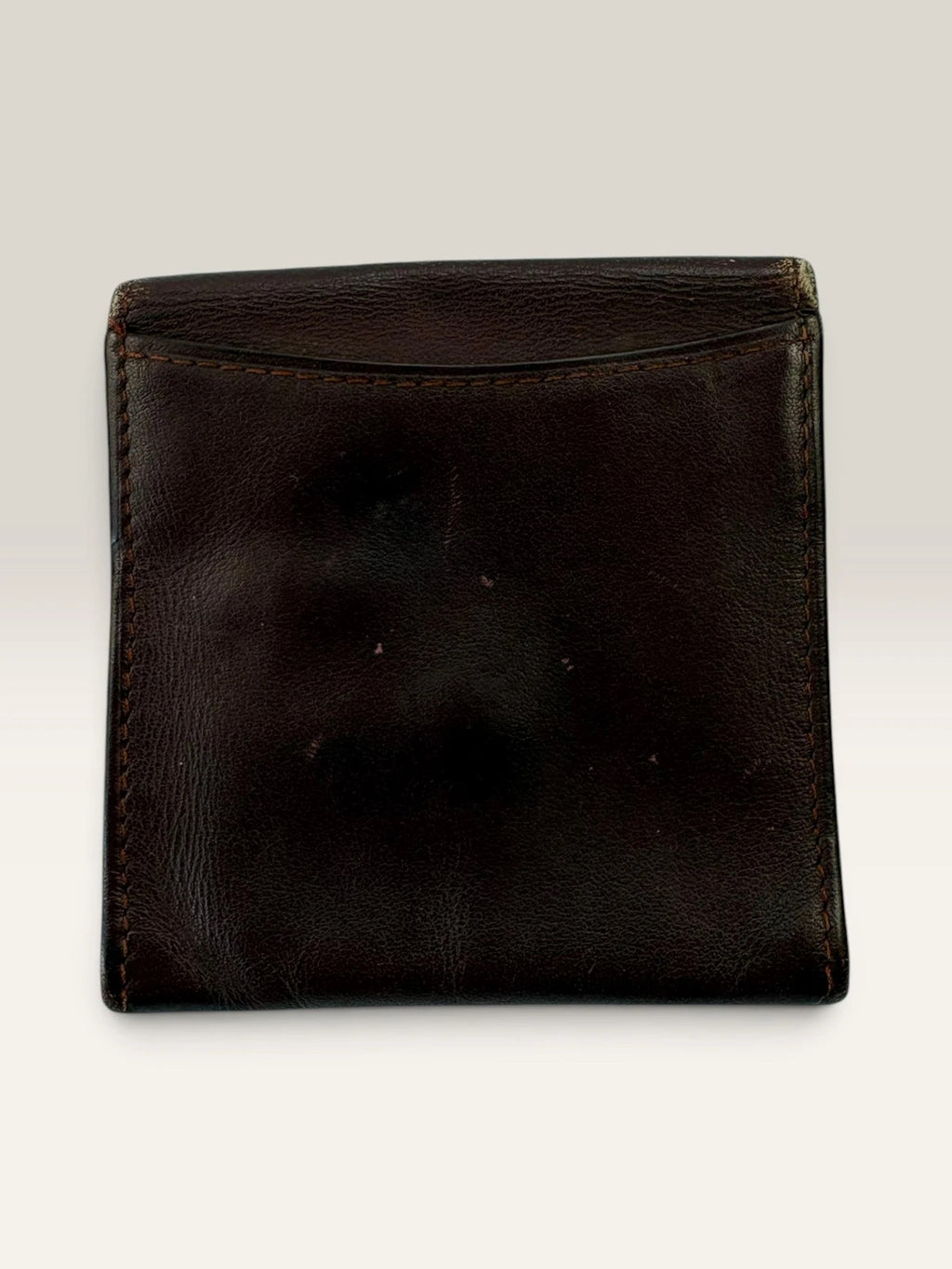 Cartier burgundy leather coin purse embossed logo with gold-tone corner hardware.