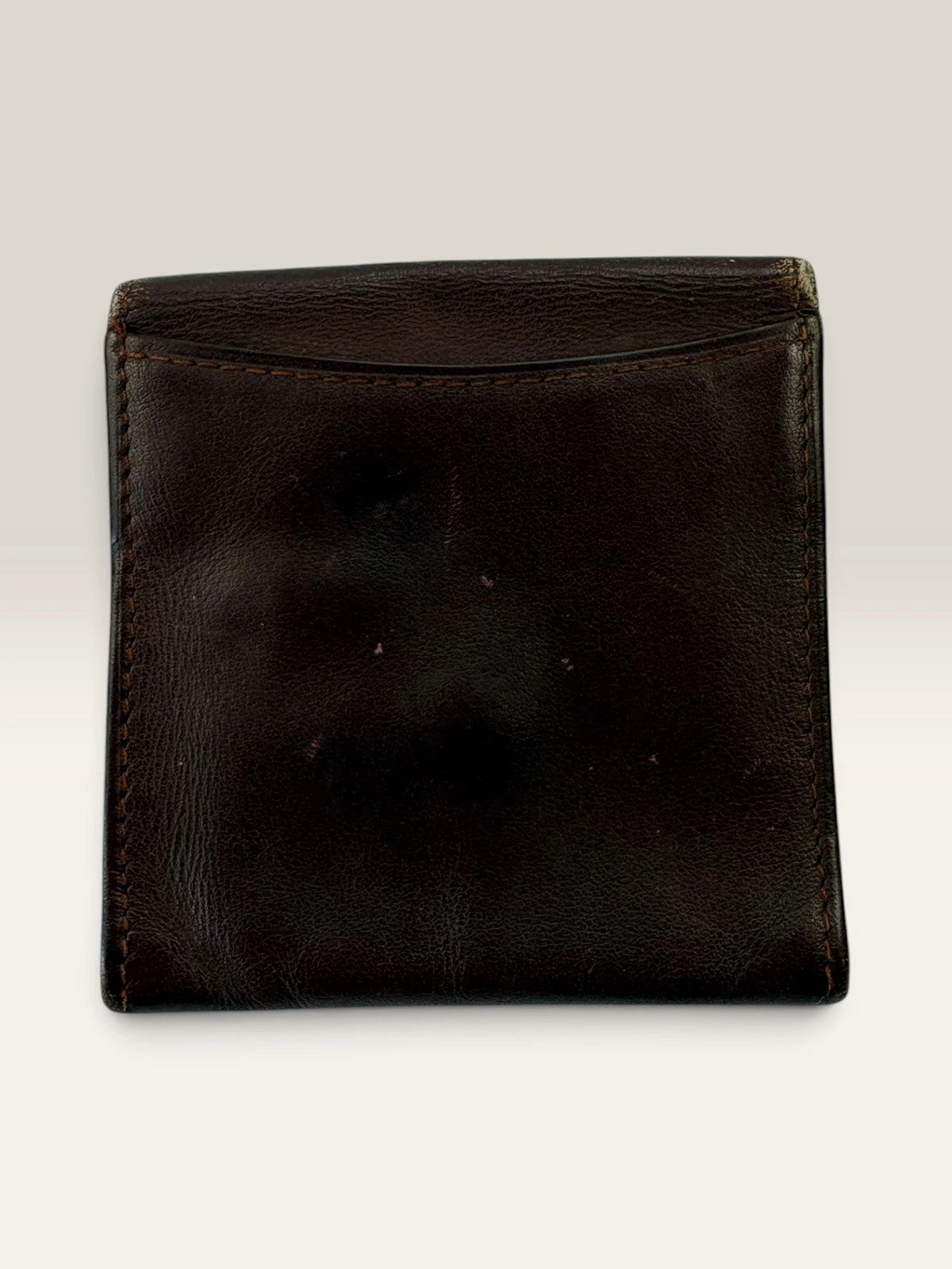 Cartier burgundy leather coin purse embossed logo with gold-tone corner hardware.