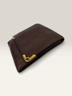 Cartier burgundy leather coin purse embossed logo with gold-tone corner hardware.