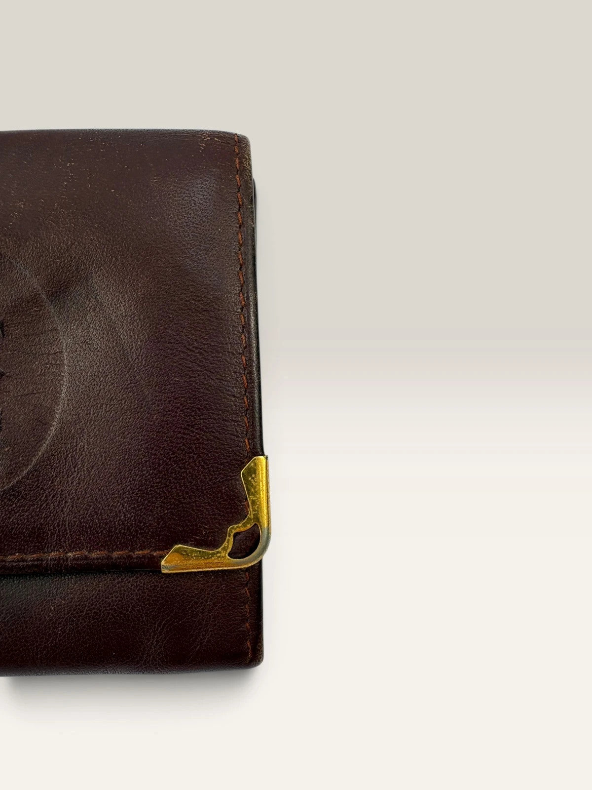 Cartier burgundy leather coin purse embossed logo with gold-tone corner hardware.