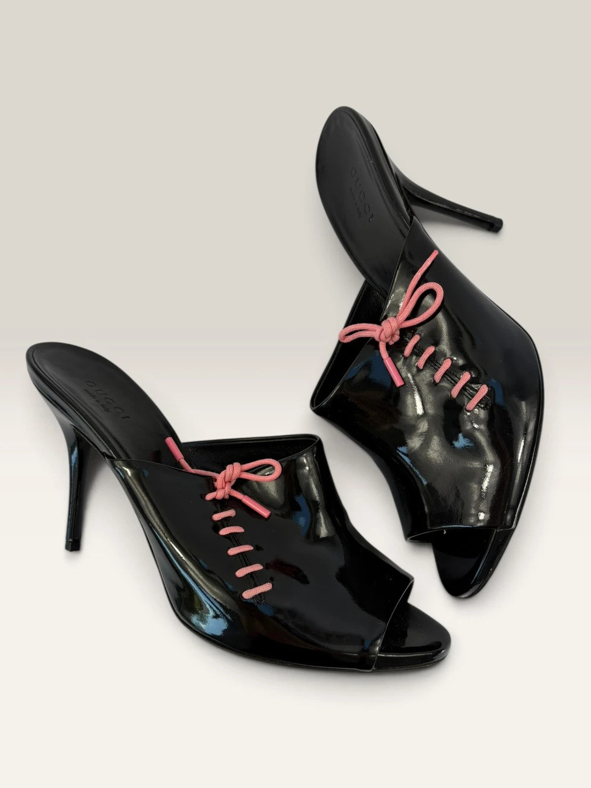 Gucci black patent leather mule heels with blush pink lace detailing from Tom Ford era.