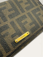Fendi brown long wallet purse with Zucca FF monogram and gold-tone logo hardware.