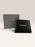 Balenciaga black bifold wallet grained leather with white cash logo print.