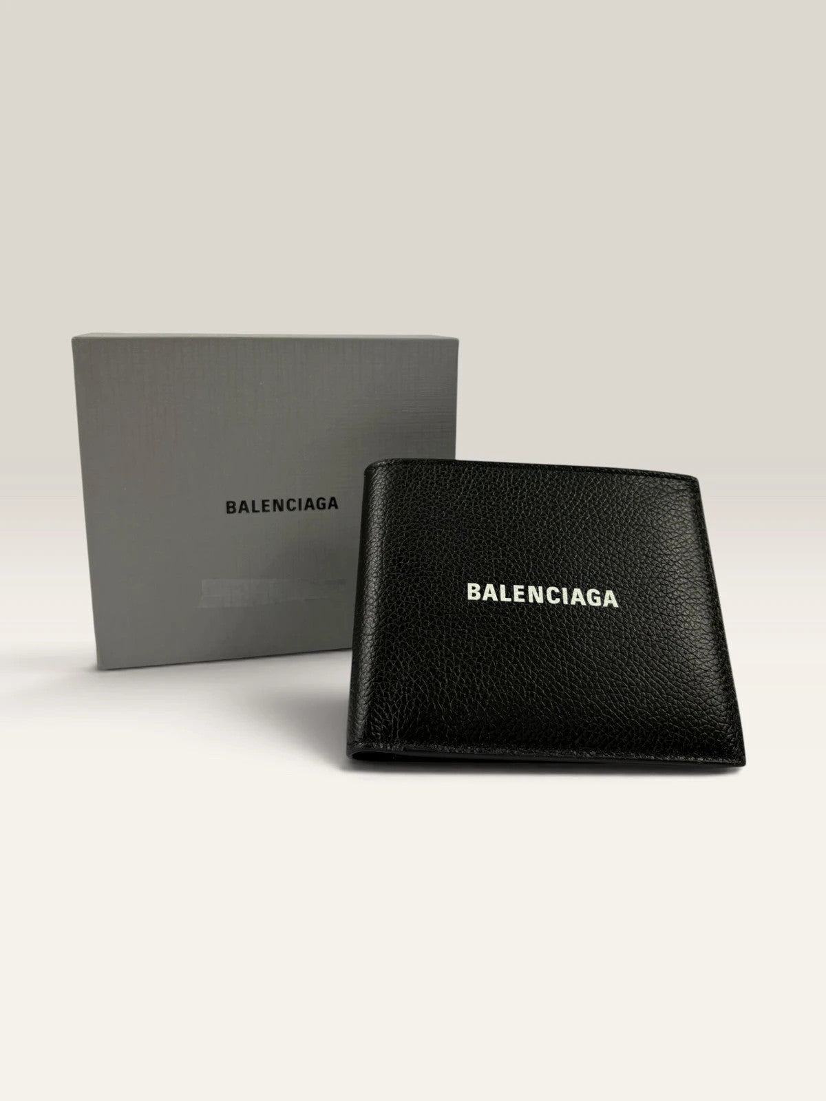 Balenciaga black bifold wallet grained leather with white cash logo print.