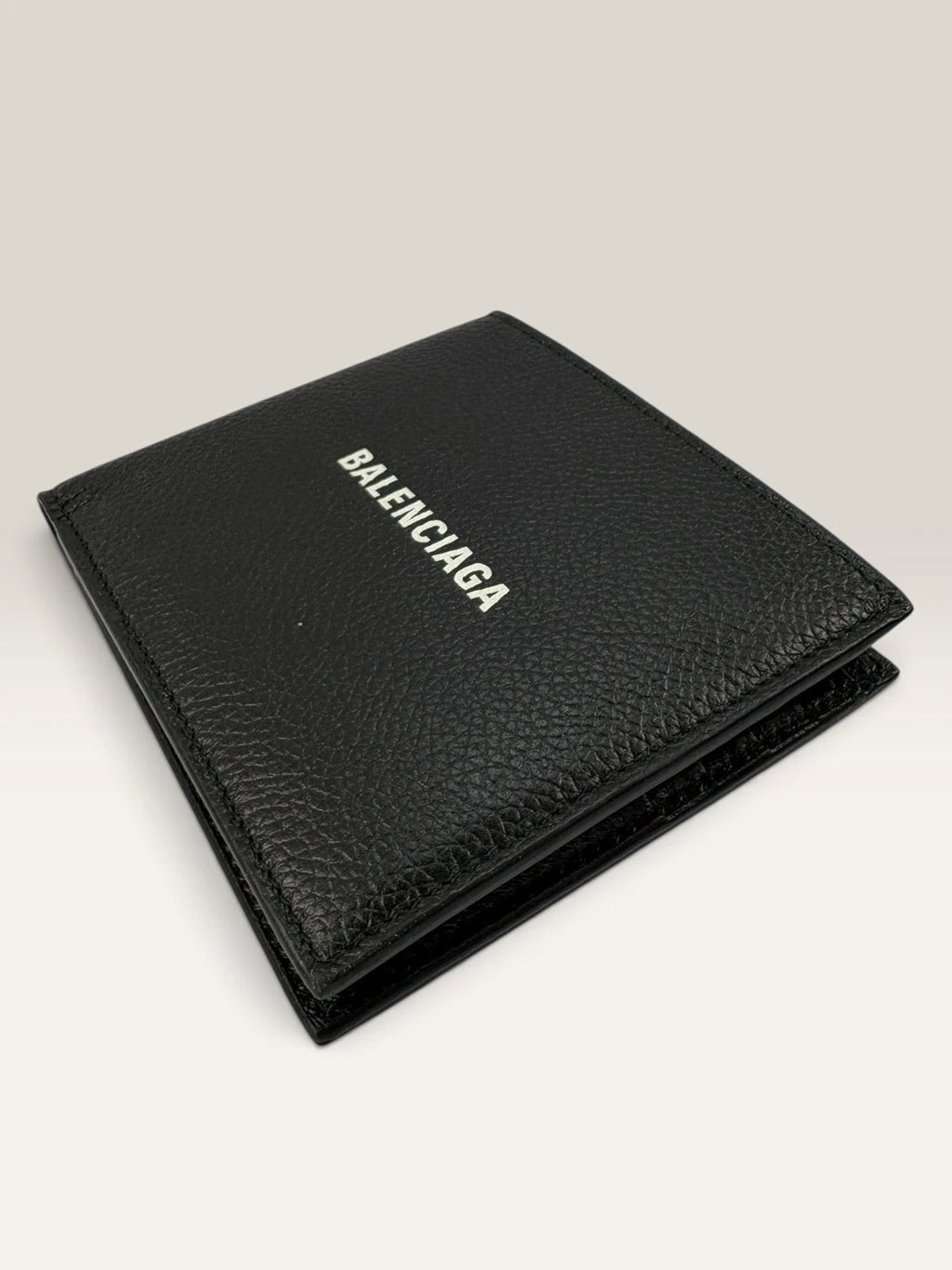 Balenciaga black bifold wallet grained leather with white cash logo print.