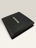Balenciaga black bifold wallet grained leather with white cash logo print.
