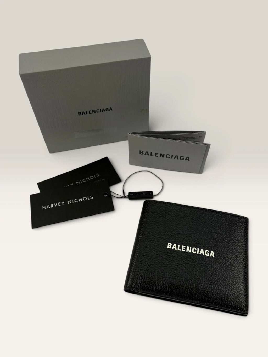 Balenciaga black bifold wallet grained leather with white cash logo print.