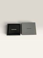 Balenciaga black bifold wallet grained leather with white cash logo print.