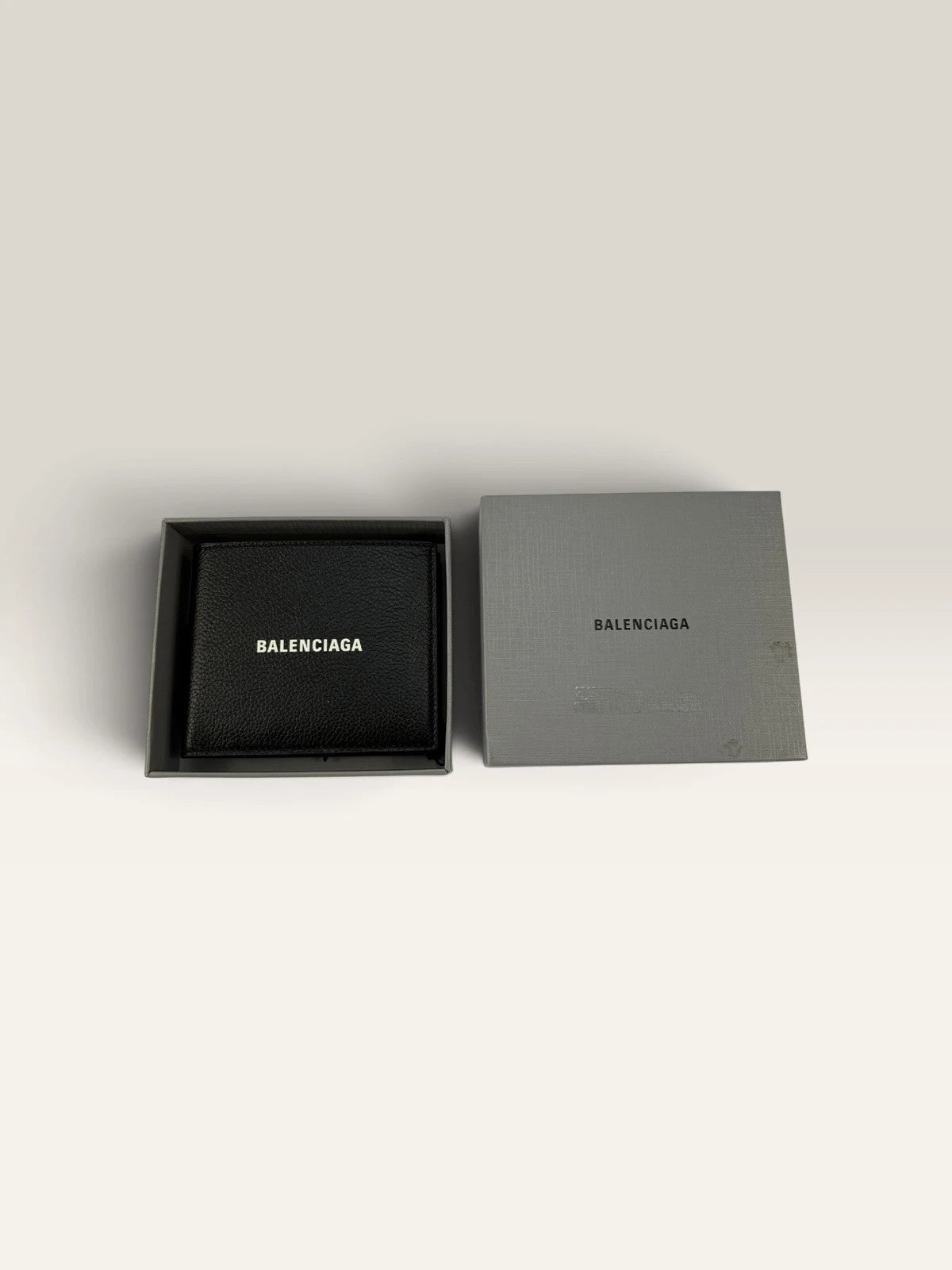 Balenciaga black bifold wallet grained leather with white cash logo print.