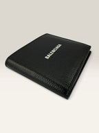 Balenciaga black bifold wallet grained leather with white cash logo print.