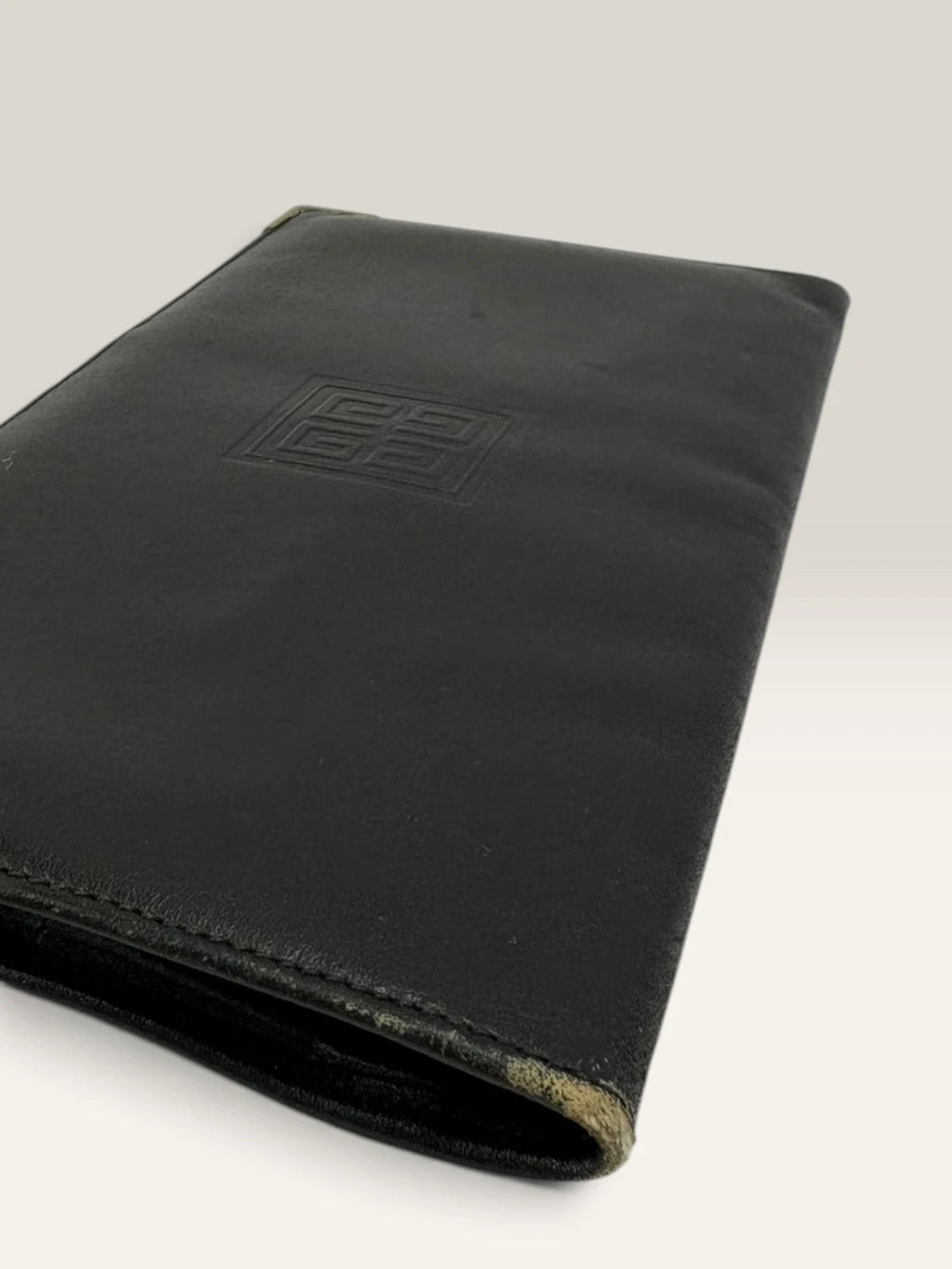Givenchy black leather wallet embossed 4G logo, smooth texture, vintage condition.