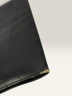 Givenchy black leather wallet embossed 4G logo, smooth texture, vintage condition.