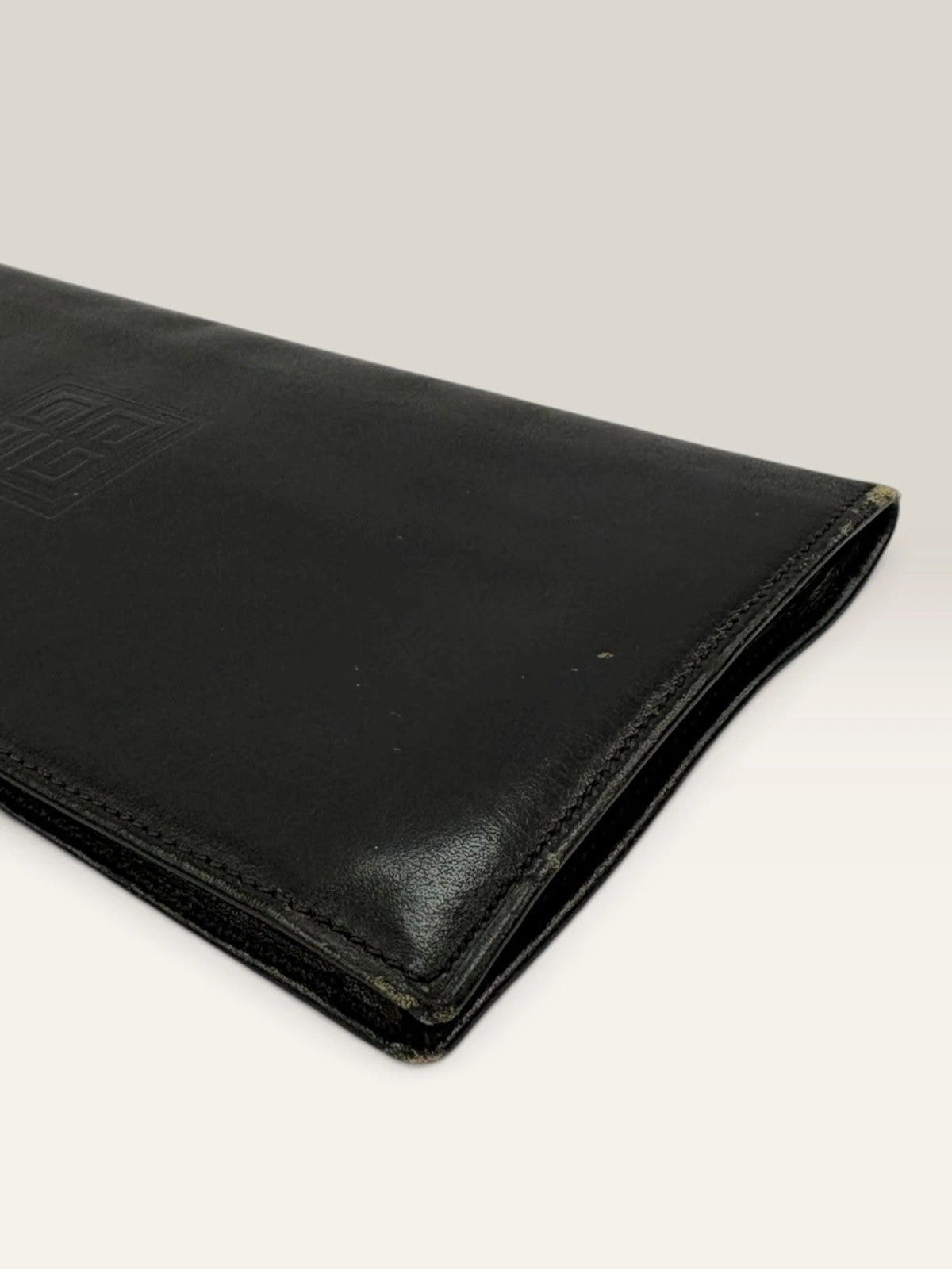 Givenchy black leather wallet embossed 4G logo, smooth texture, vintage condition.