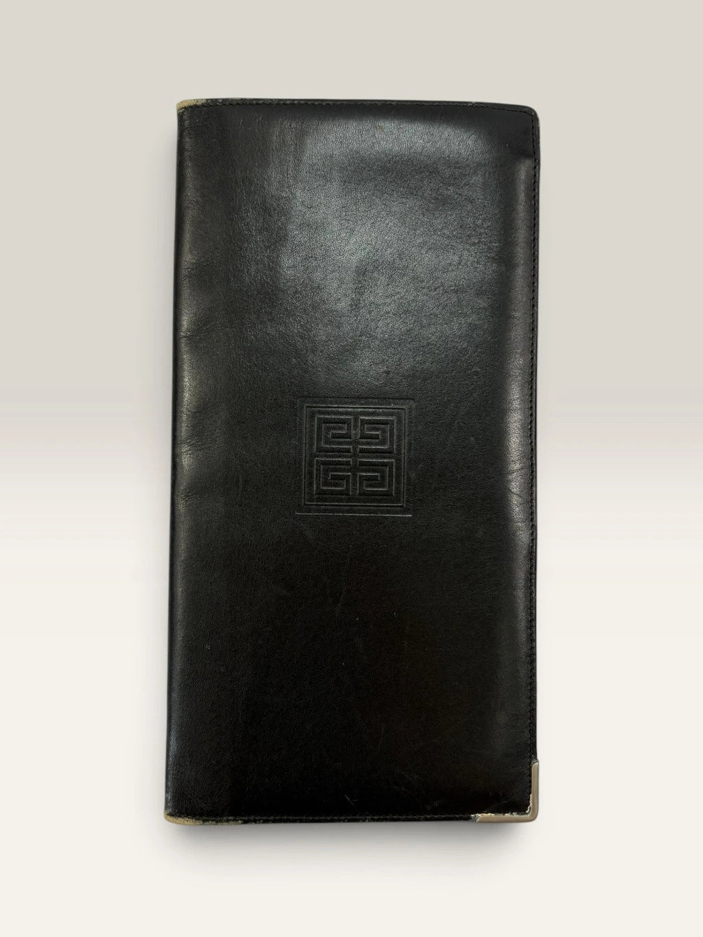 Givenchy black leather wallet embossed 4G logo, smooth texture, vintage condition.