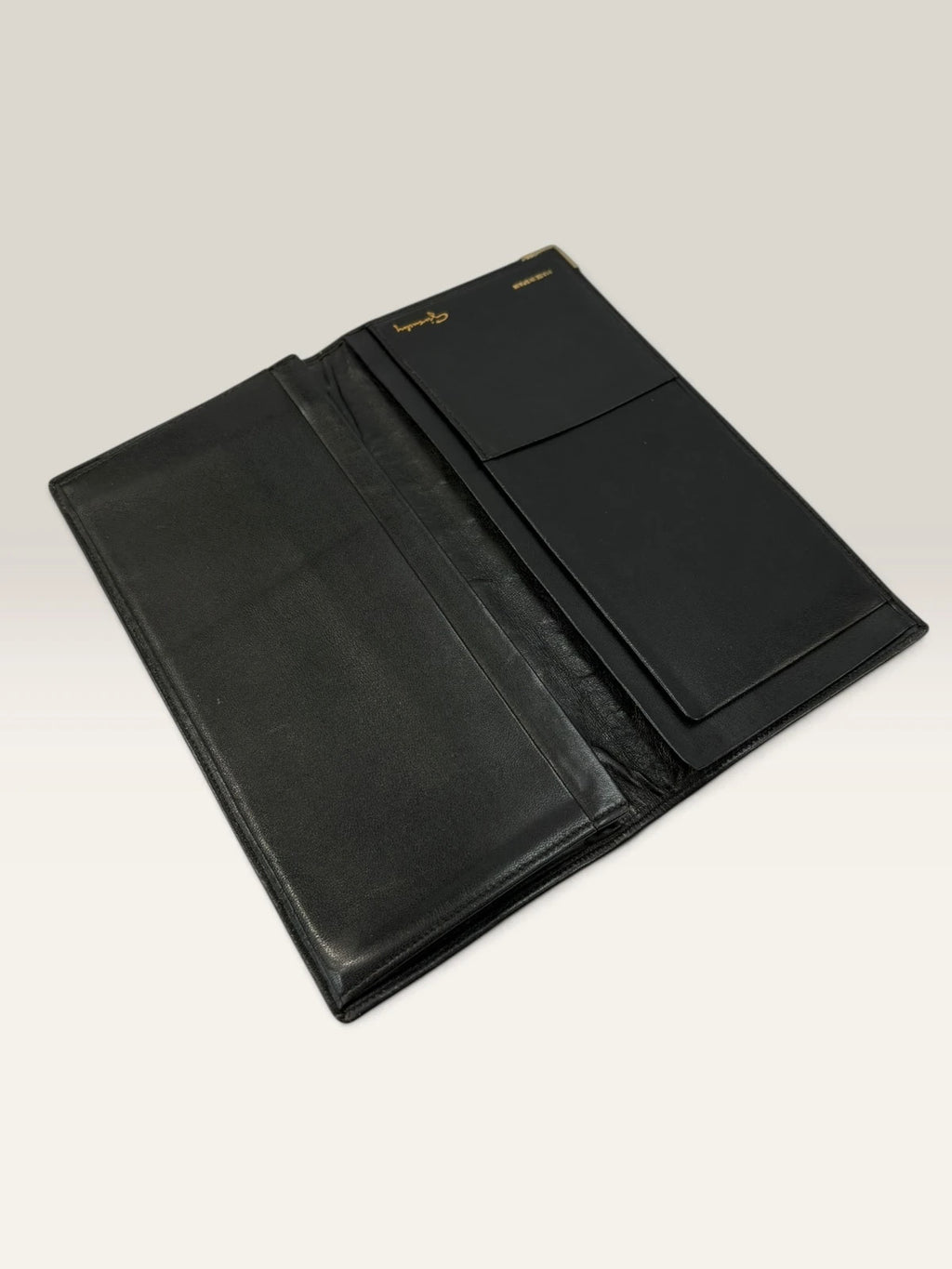 Givenchy black leather wallet embossed 4G logo, smooth texture, vintage condition.