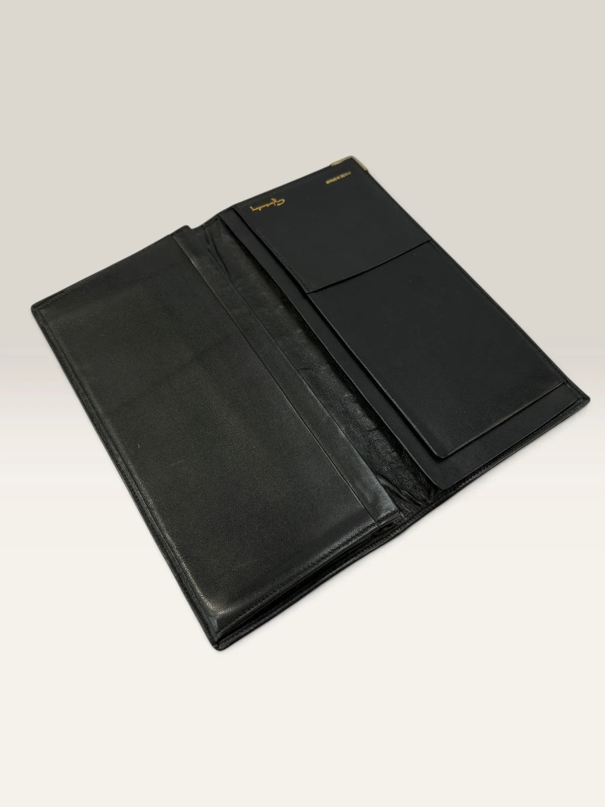 Givenchy black leather wallet embossed 4G logo, smooth texture, vintage condition.