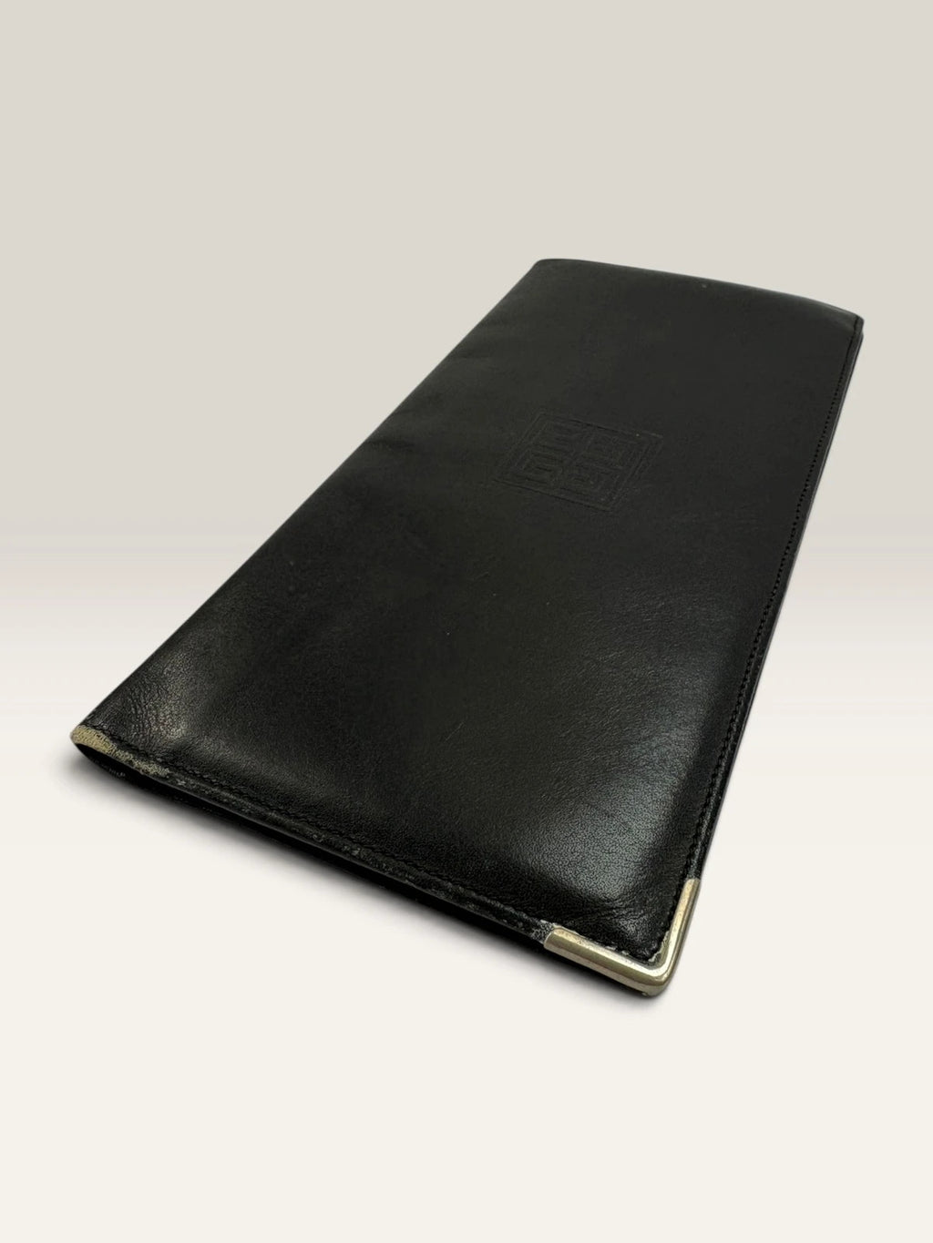 Givenchy black leather wallet embossed 4G logo, smooth texture, vintage condition.
