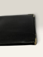 Givenchy black leather wallet embossed 4G logo, smooth texture, vintage condition.