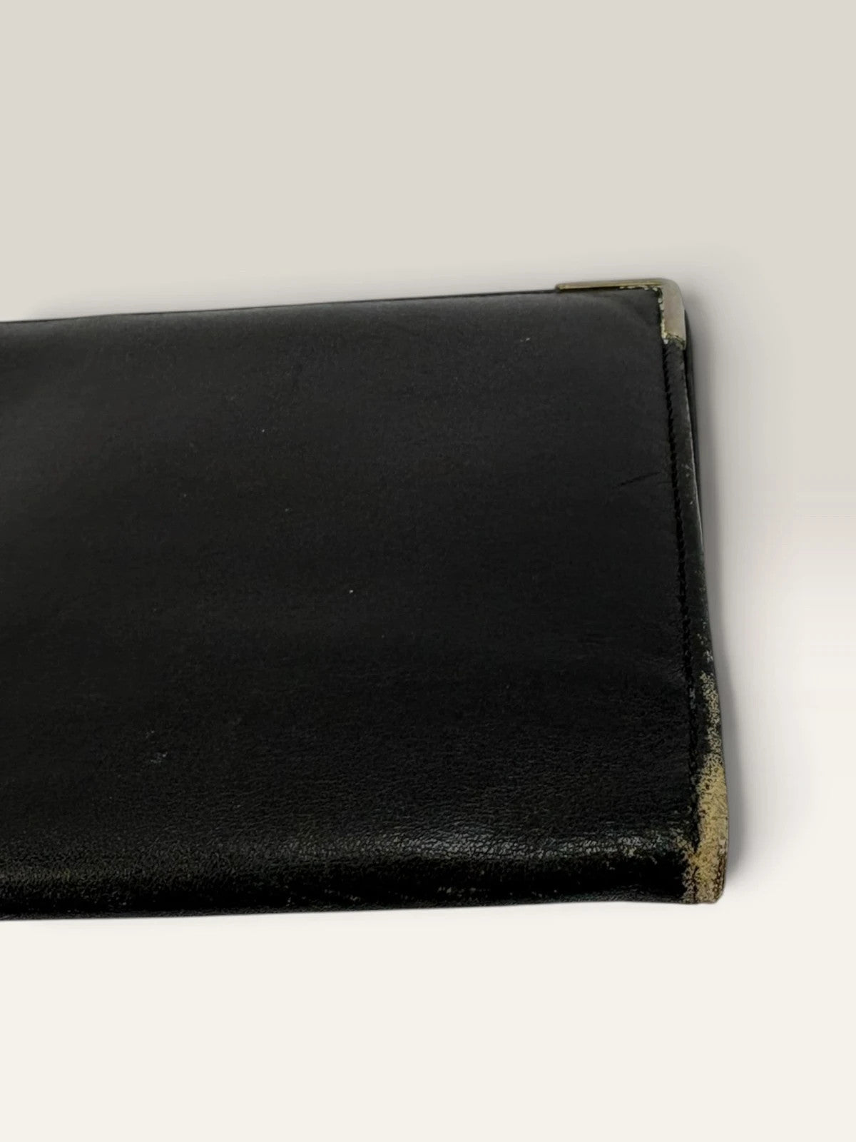 Givenchy black leather wallet embossed 4G logo, smooth texture, vintage condition.