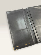 Givenchy black leather wallet embossed 4G logo, smooth texture, vintage condition.
