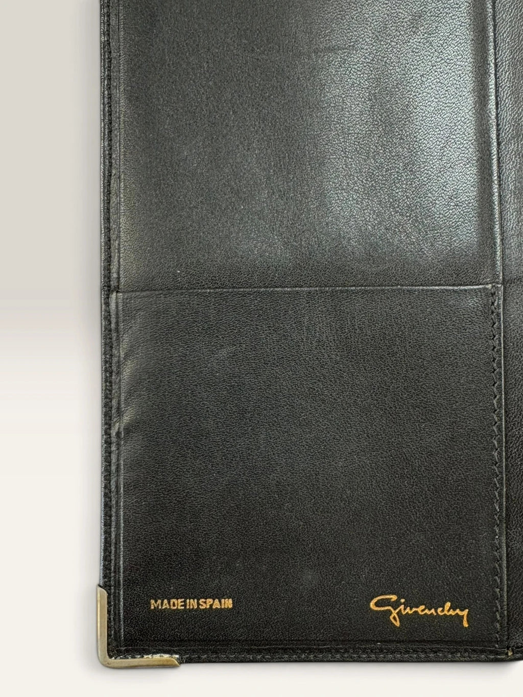 Givenchy black leather wallet embossed 4G logo, smooth texture, vintage condition.