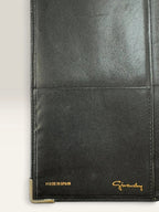 Givenchy black leather wallet embossed 4G logo, smooth texture, vintage condition.