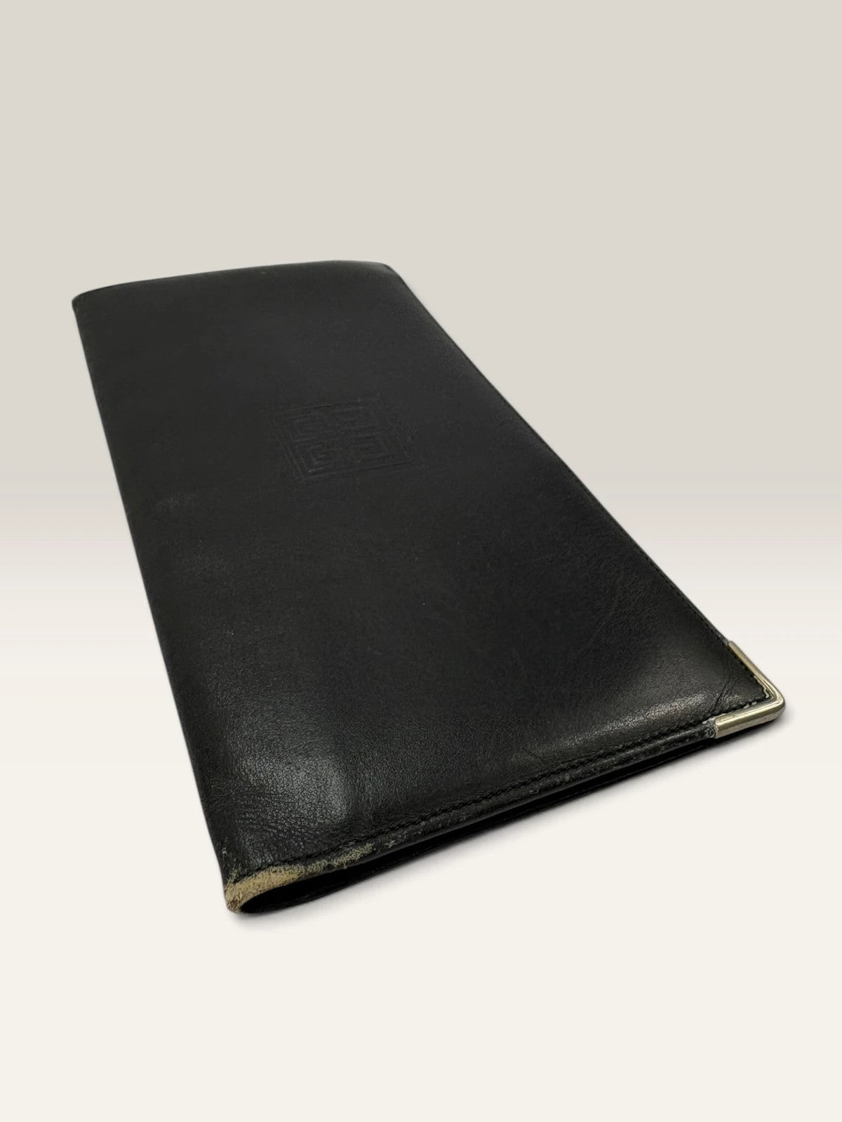 Givenchy black leather wallet embossed 4G logo, smooth texture, vintage condition.