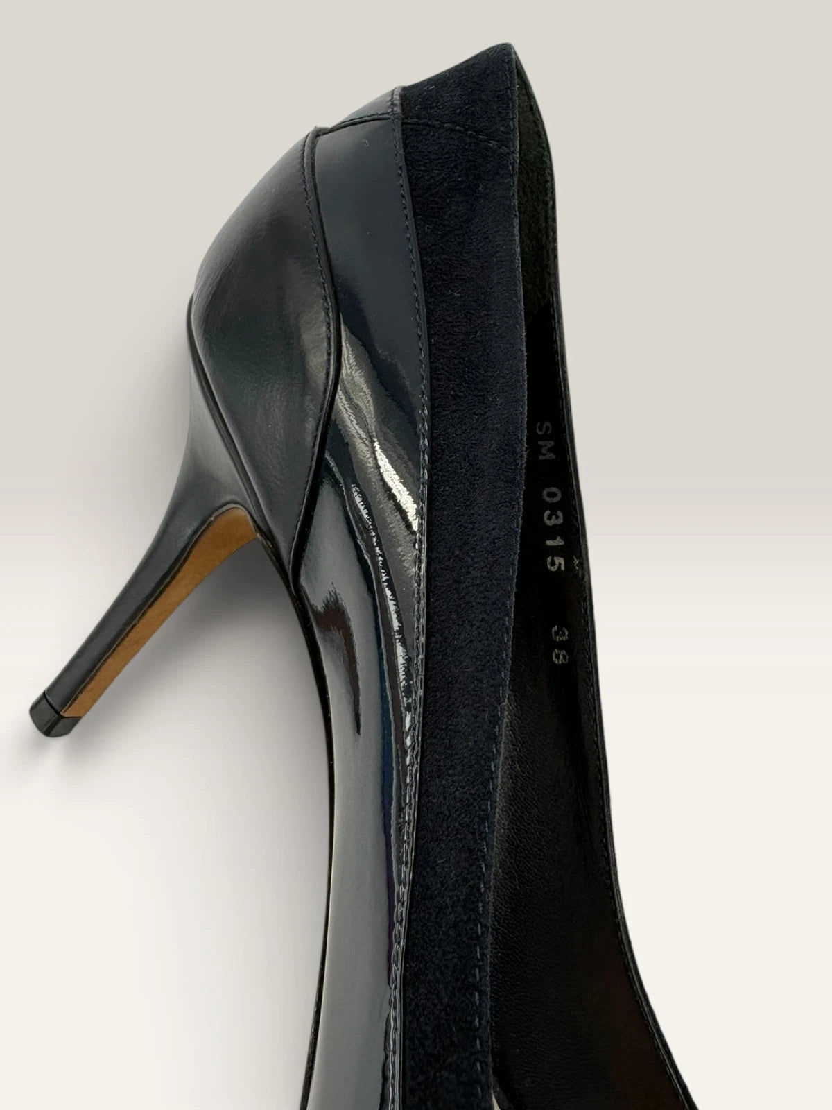 Dior navy blue stiletto heels in suede and patent leather with pointed toe design.