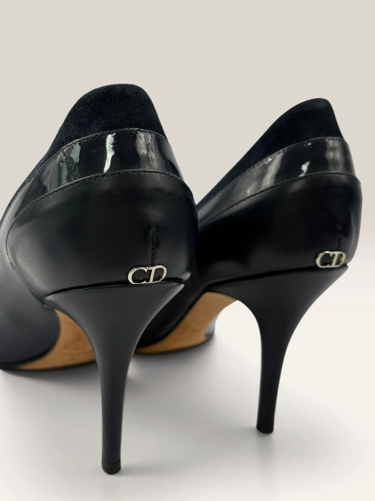 Dior navy blue stiletto heels in suede and patent leather with pointed toe design.