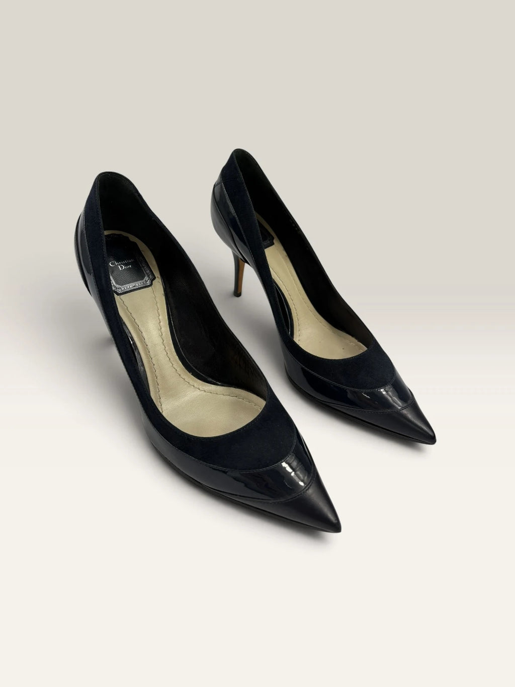 Dior navy blue stiletto heels in suede and patent leather with pointed toe design.