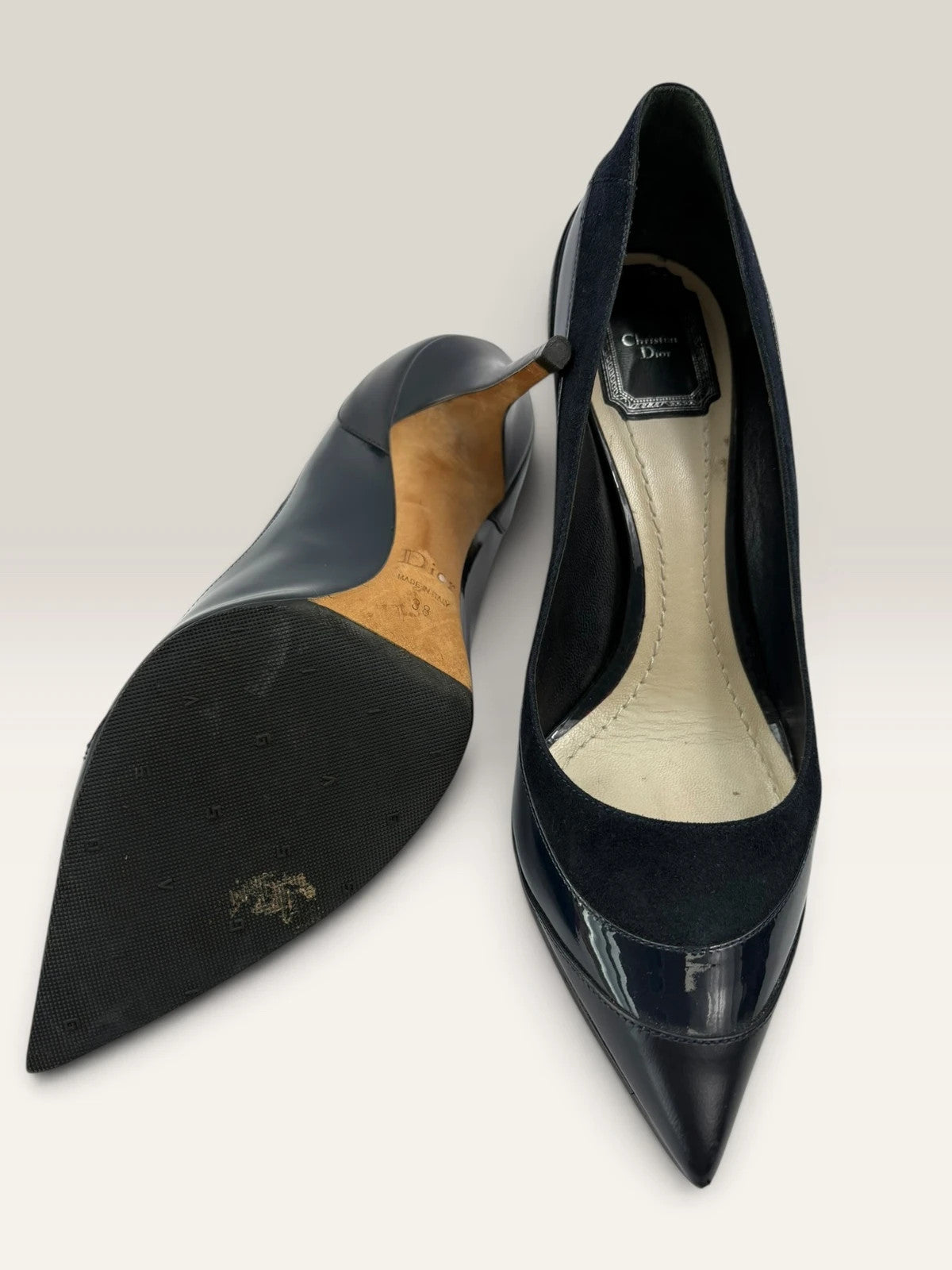 Dior navy blue stiletto heels in suede and patent leather with pointed toe design.