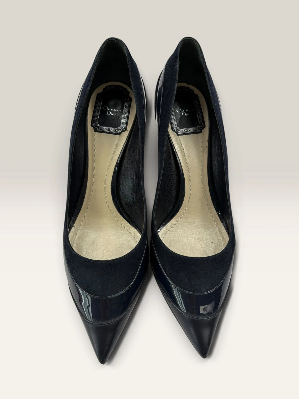 Dior navy blue stiletto heels in suede and patent leather with pointed toe design.