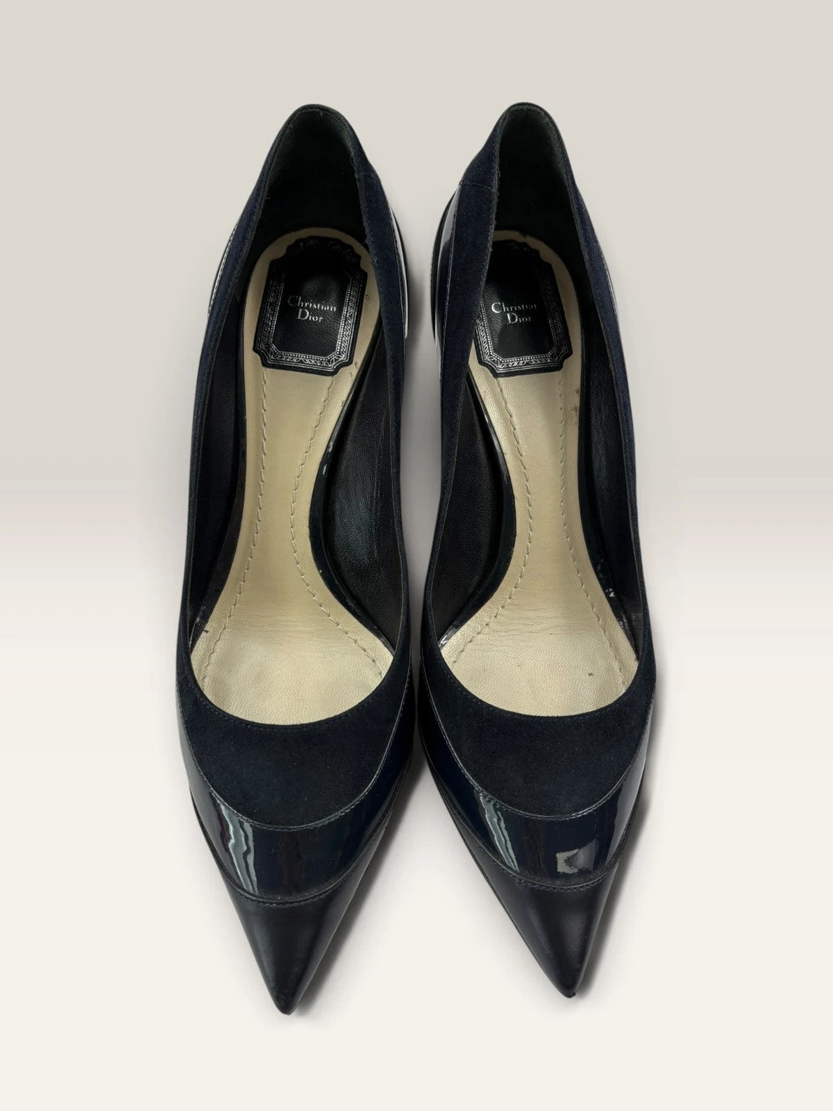 Dior navy blue stiletto heels in suede and patent leather with pointed toe design.