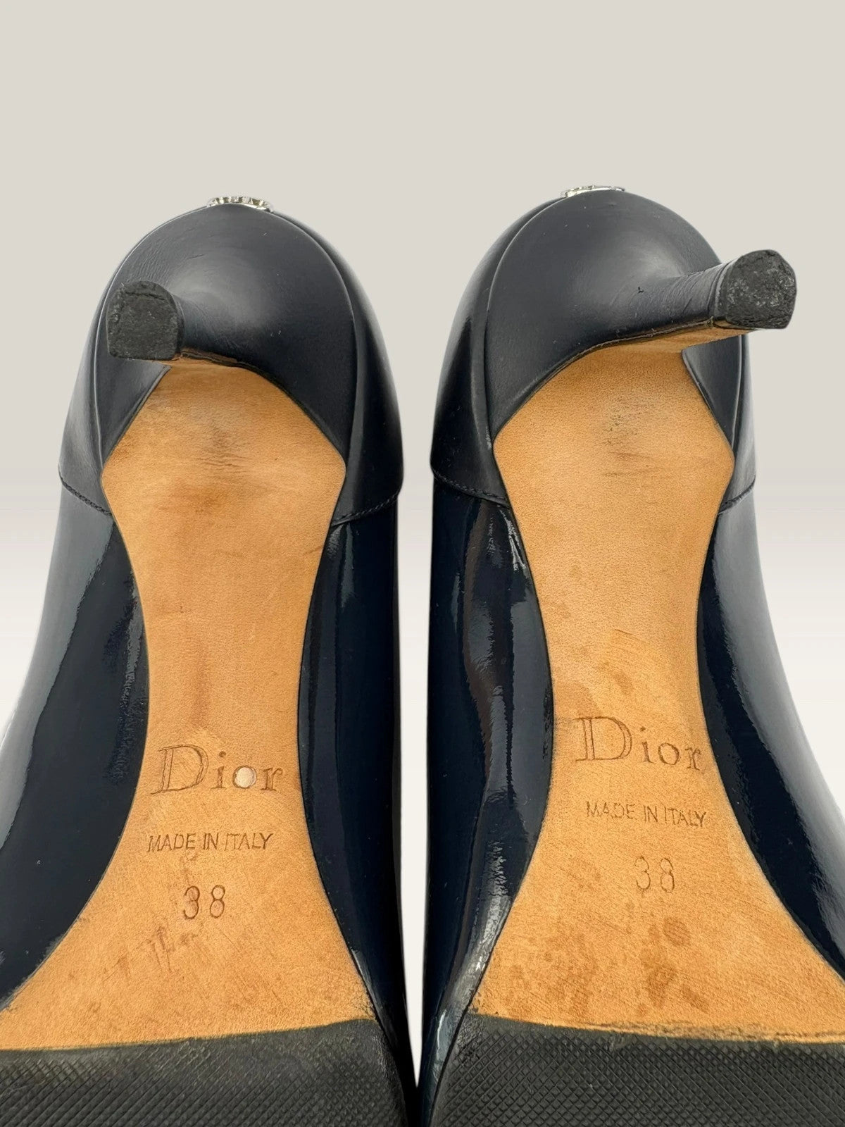 Dior navy blue stiletto heels in suede and patent leather with pointed toe design.