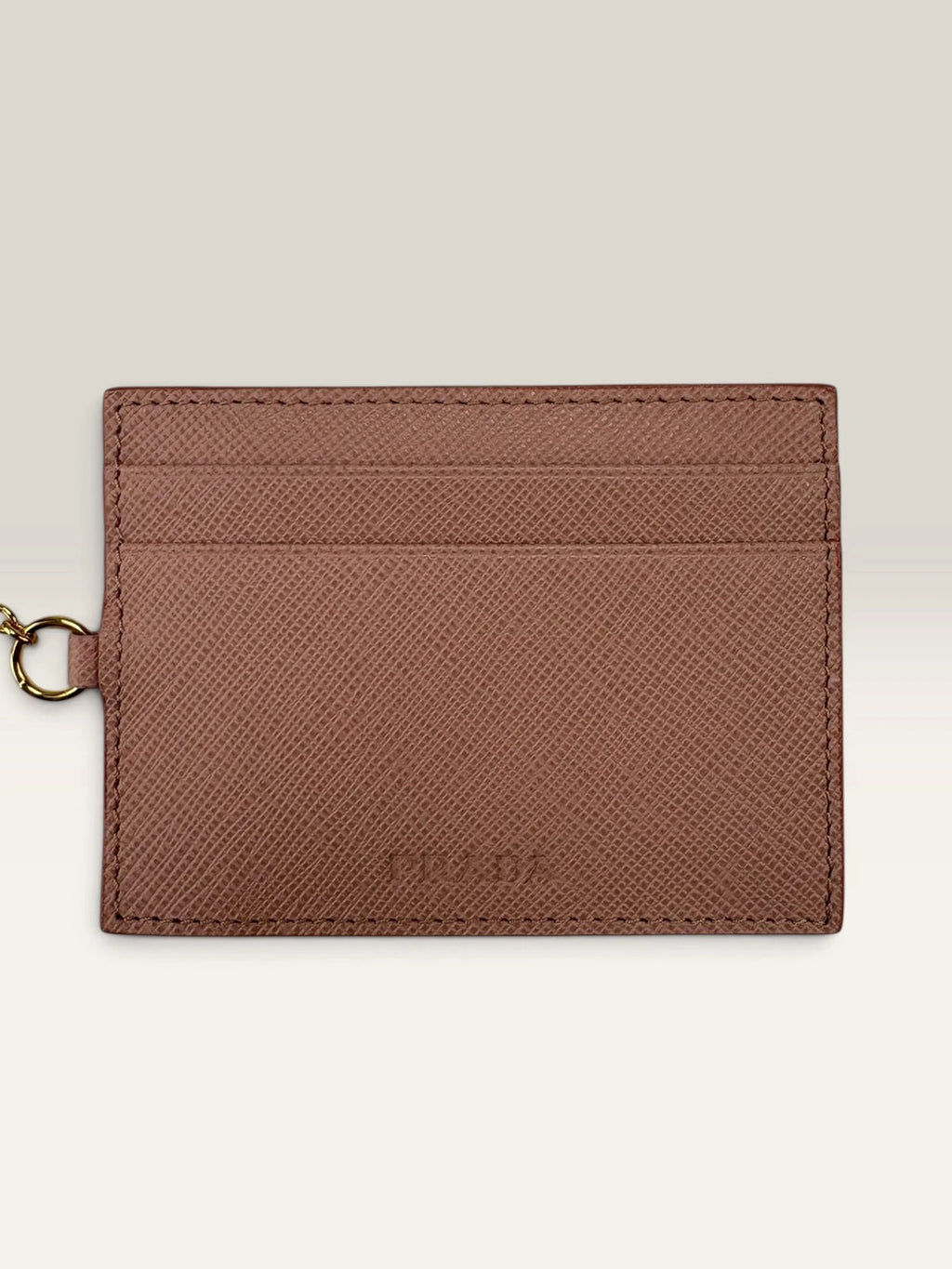 Prada pink leather wallet with structured bow detail and gold-tone hardware.