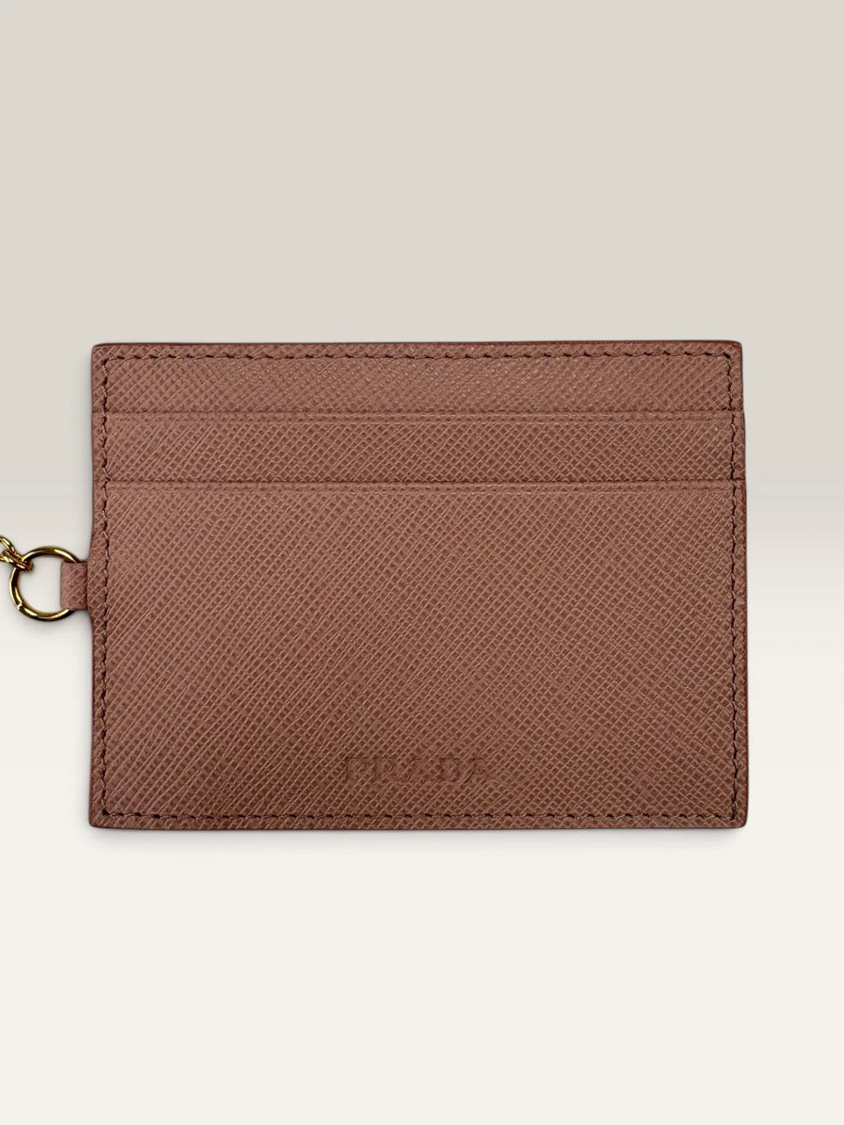 Prada pink leather wallet with structured bow detail and gold-tone hardware.