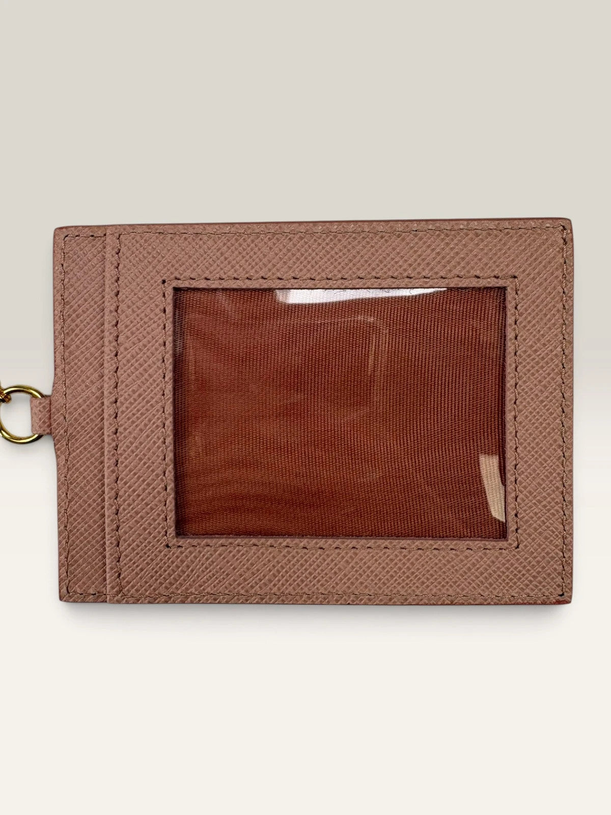 Prada pink leather wallet with structured bow detail and gold-tone hardware.