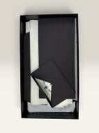 Prada pink leather wallet with structured bow detail and gold-tone hardware.