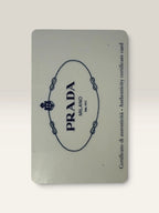 Prada pink leather wallet with structured bow detail and gold-tone hardware.