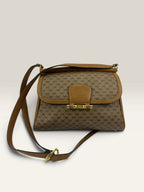 Gucci beige GG monogram canvas shoulder bag with brown leather trim and gold-tone hardware.