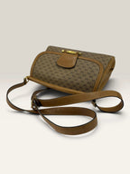 Gucci beige GG monogram canvas shoulder bag with brown leather trim and gold-tone hardware.